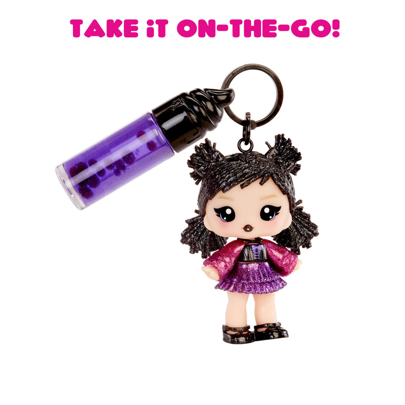 Toy keychain with a small doll and lip gloss on a white background with text 'Take it on-the-go!'.