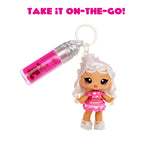 Toy keychain with a small doll and lip gloss on a white background with text 'Take it on-the-go!