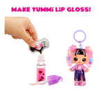 Make Yummi Lip Gloss toy set with a hand holding a lip gloss container, a character figurine, and a lip gloss bottle on a white background.