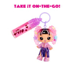 Keychain with a small doll and pink container on a white background with text 'Take it on-the-go!'.