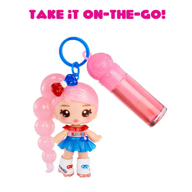 Toy keychain with a small doll and pink lip gloss on a white background with text 'Take it on-the-go!'.