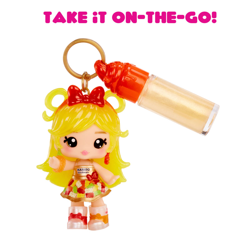 Keychain with a small doll figure and lip gloss on a white background with text 'Take it on-the-go!'.