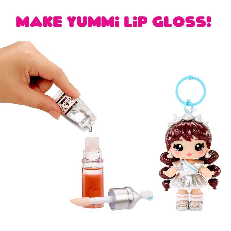 Make Yummi lip gloss kit with a doll and lip gloss applicator on a white background