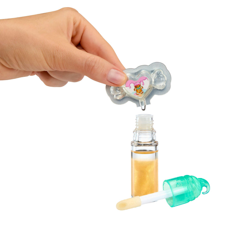 Hand holding a small bottle with a dropper and a bottle cap on a white background