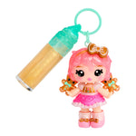Toy figure with pink hair and gingerbread-themed accessories next to a small container on a white background