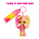 Toy figure with pink and yellow hair accessory and keychain on a white background