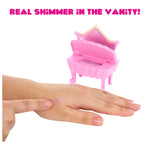 Pink makeup vanity with hand applying shimmer on a white background