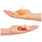 Two hands holding miniature food items 