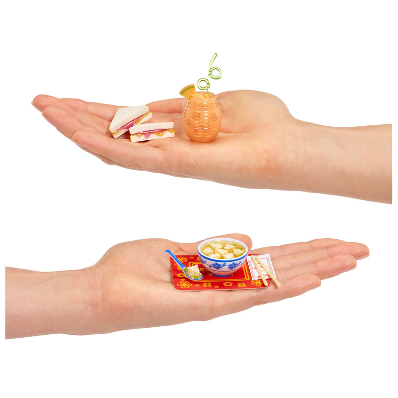 Two hands holding miniature food items 