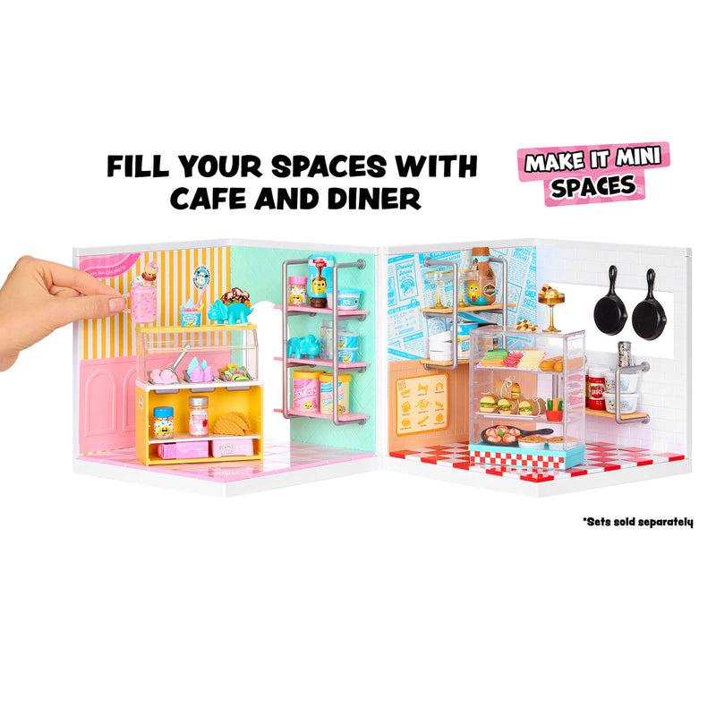 Toy cafe and diner set with a hand holding it open, on a white background.