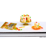 Miniature cake and candy display with HARIBO packaging on a white background