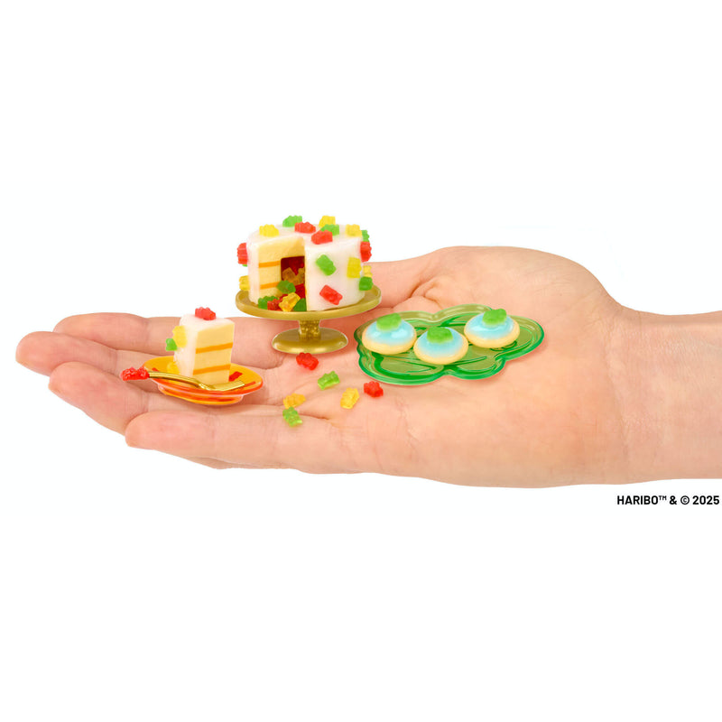 Colorful creations on palm of a hand with 'HARIBO' branding.