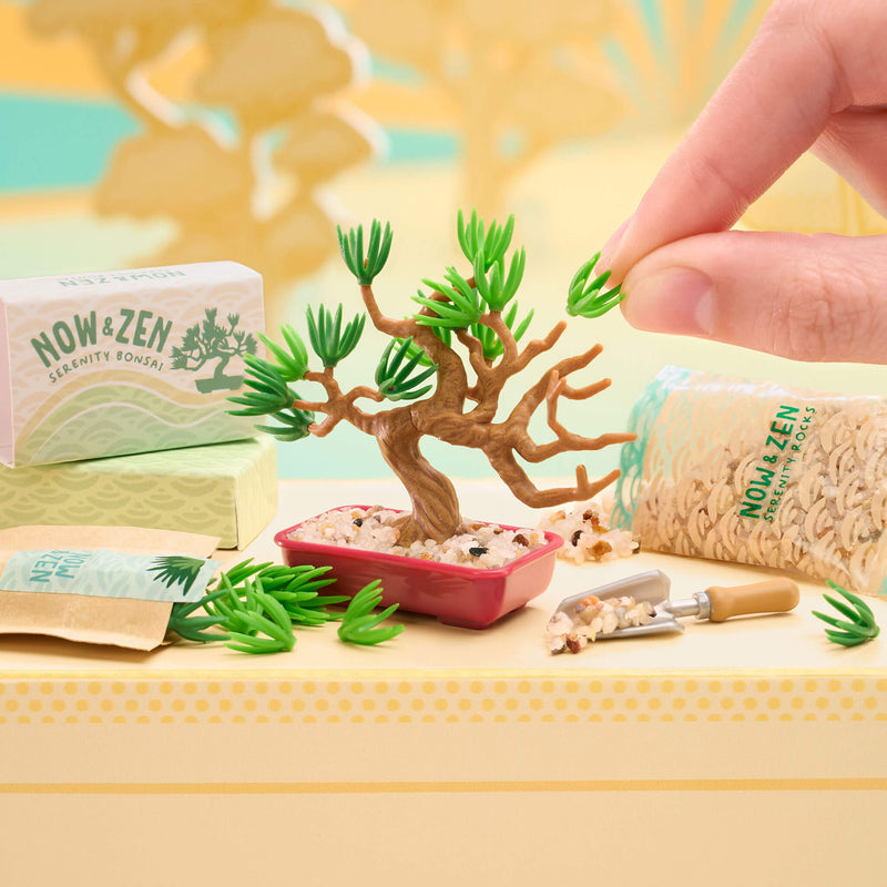 Now & Zen product set with a small bonsai tree and packaging on a yellow background