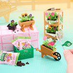 Miniature gardening set with plants and tools on a colorful background