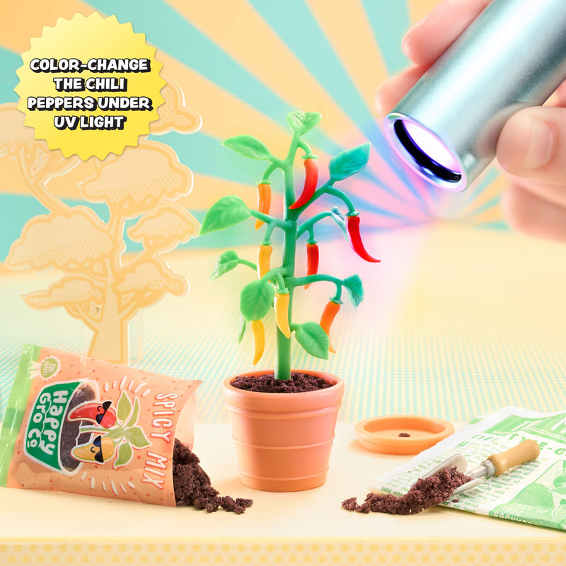 Plant with color-changing peppers under UV light, next to a packet of seeds and a small lamp.