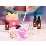 Mini Perfume bottles and a dropper with a pink bottle on a white surface.