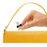 putting mini perfume in purse