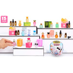 Display of all fifteen perfume bottles with a hand reaching out to pick one, on a white background.