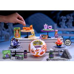 Collection of Halloween-themed toys and decorations on a table with a blurred background.