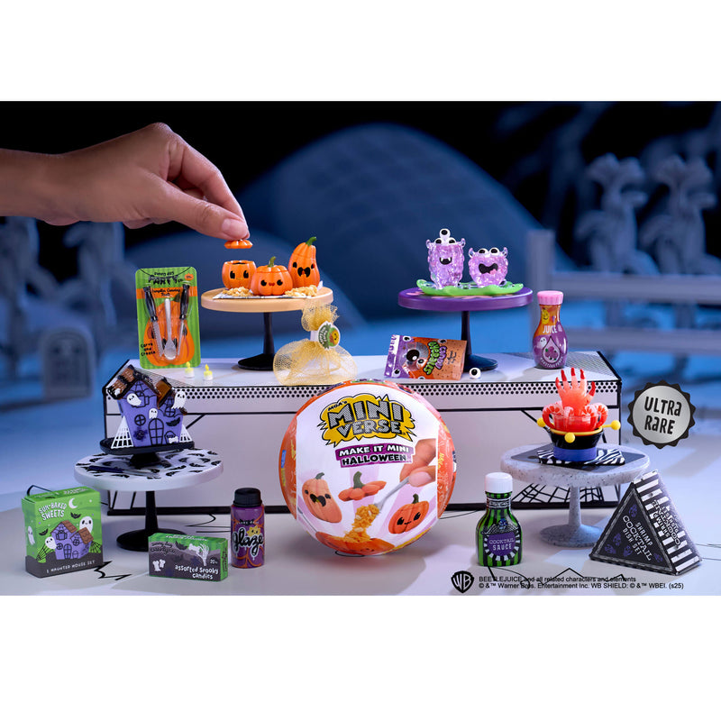 Collection of Halloween-themed toys and decorations on a table with a blurred background.