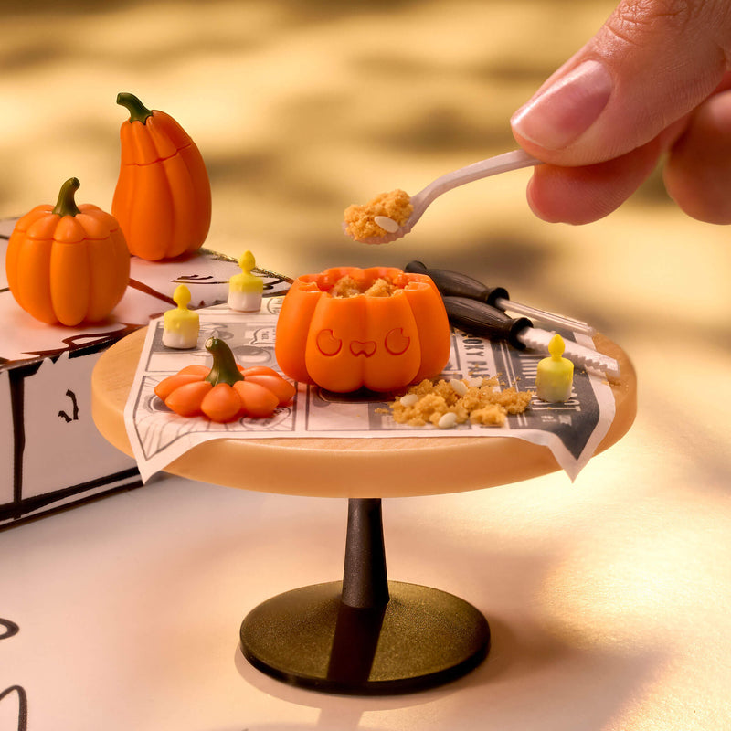 Pumpkin on a stand with a hand holding a spoon over it, set against a warm-toned background.