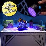 Halloween-themed items including a haunted house, boxes, and a UV light on a table.