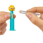 Small sun Pez with a blue handle held by a hand against a white background