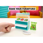 Miniature salad bar with a hand interacting with it, set against a colorful background.