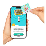 Hand holding a smartphone with a 'MiniVerse' app open, ready to scan a recipe card.