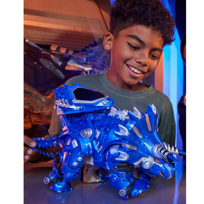 Child holding a blue toy dinosaur with a colorful background