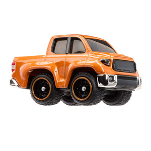 Orange toy truck with large wheels on a white background