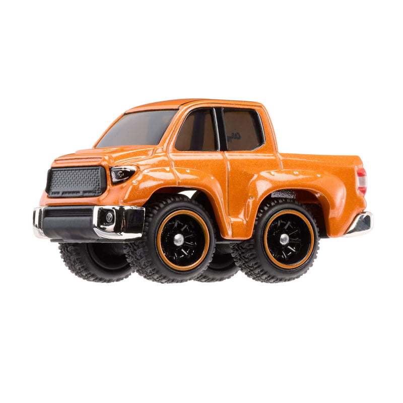 Orange toy truck with large wheels on a white background