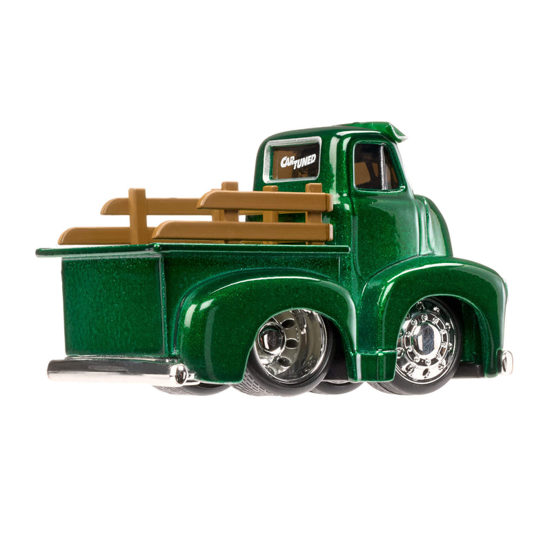 Green toy truck with a brown bed on a white background