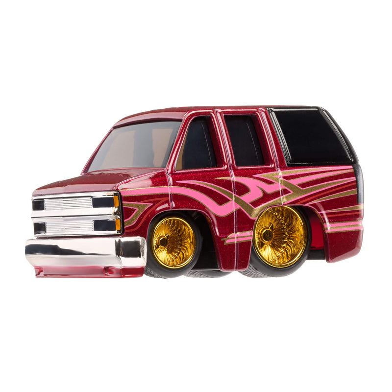 Red toy SUV with gold wheel rims on a white background