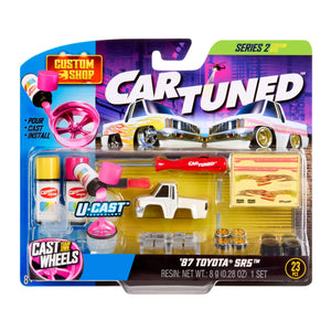 Packaged toy car with accessories and tools on a white background
