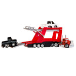 Toy semi with a trailer carrying another toy truck on a white background