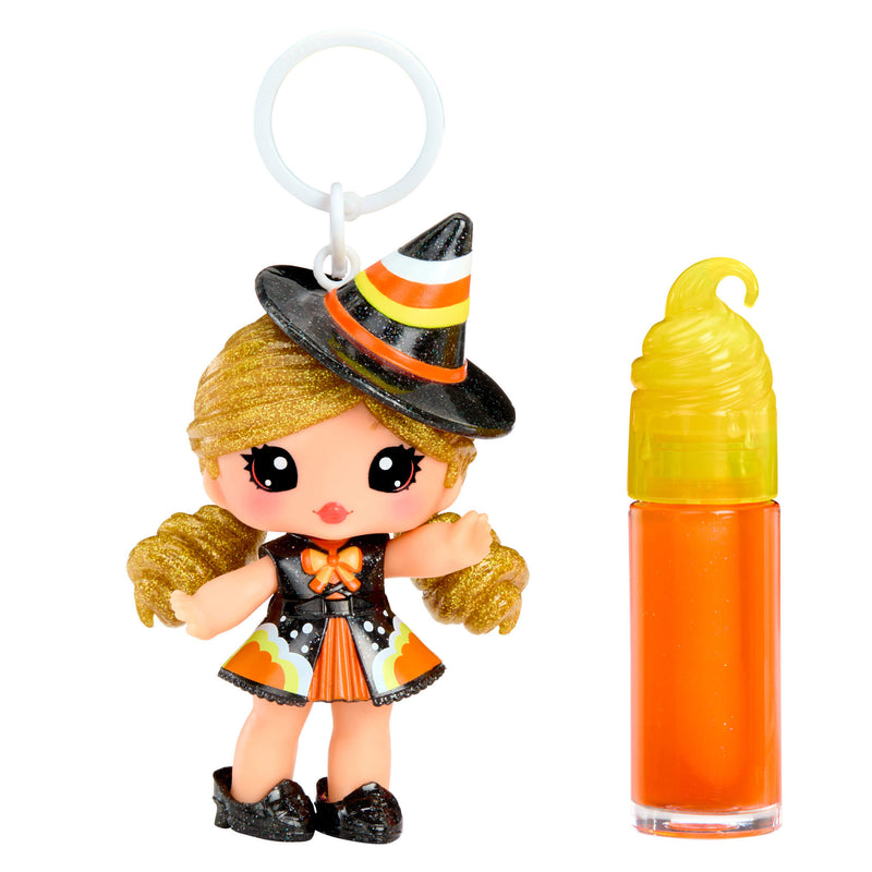 Halloween-themed figurine with a small bottle of orange liquid on a white background