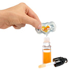 Hand putting scent into a small bottle on a white background