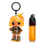 Keychain figure with orange hair and a bottle of orange-colored product on a white background