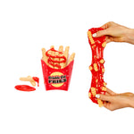 Fries being stretched next to a box of fries and ketchup.