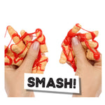 Two hands holding cheesy snack sticks with red sauce, labeled 'SMASH!'.