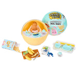 Miniature baby with accessories on a white background