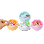 Set of mini babies and accessories in colorful ball displays on a white background