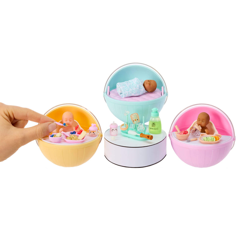 Set of mini babies and accessories in colorful ball displays on a white background