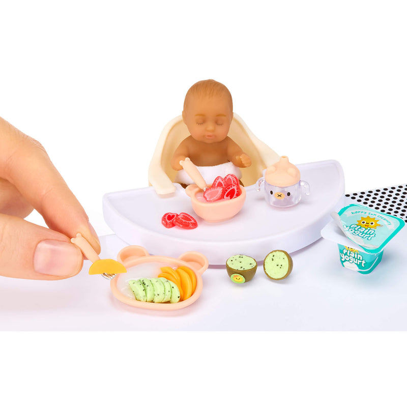 Playset with a mini baby figurine, food items, and a container labeled 'Plain Yogurt' on a white background.