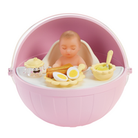 Pink baby in a high chair with food items on a white background