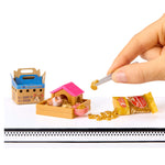 Mini hamster with a miniature pet house and food packaging on a white background