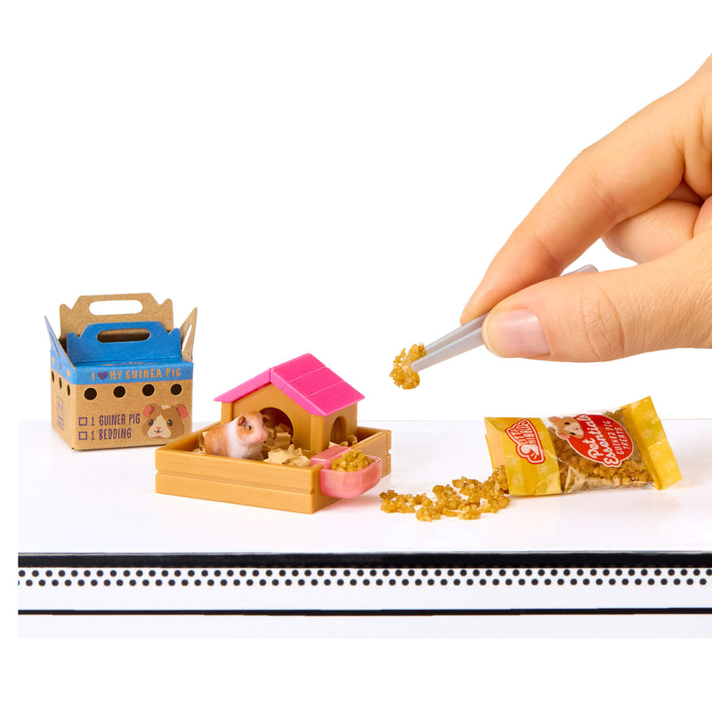 Mini hamster with a miniature pet house and food packaging on a white background