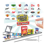 Miniature model of a snack scene with brand logos and a hand holding a small item.