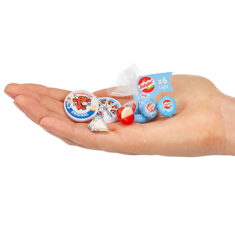 Hand holding Mini Laughing Cow Cheese in palm with visible branding on a white background